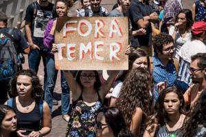 Protesters carry signs reading "Out with Temer" in September, 2016. https://flic.kr/p/LxLjpn